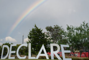 declare conference sign with rainbow in the sky